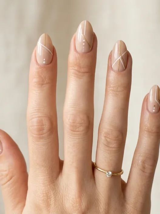 Woman's hand displaying variety of almond nail designs in elegant studio photography setup
