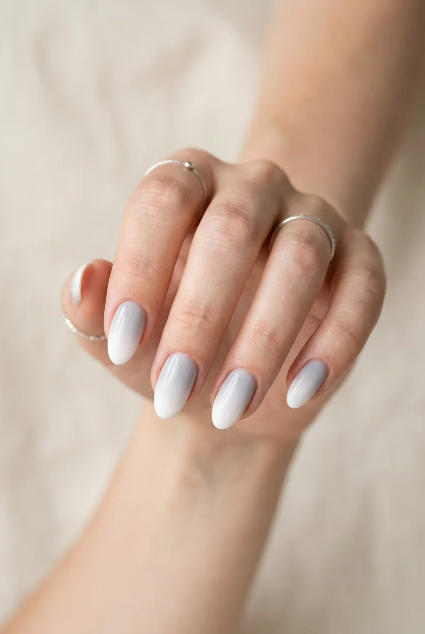 Woman's hand displaying cloud nine ombré gradient from white tips to pale gray base