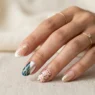 Woman's hand showing multiple nail art designs from subtle French tips to bold chrome effects