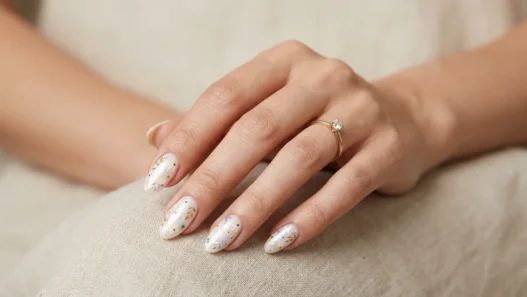 Woman's hand showing summer classy nail manicure with elegant design in soft studio lighting