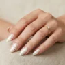 Woman's hand showing summer classy nail manicure with elegant design in soft studio lighting