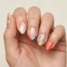 Woman's hand showing summer 2026 nail trends with mixed designs on each finger