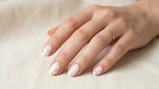 Woman's hand showing variety of nail art designs and manicure styles in elegant studio lighting