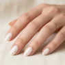 Woman's hand showing variety of nail art designs and manicure styles in elegant studio lighting